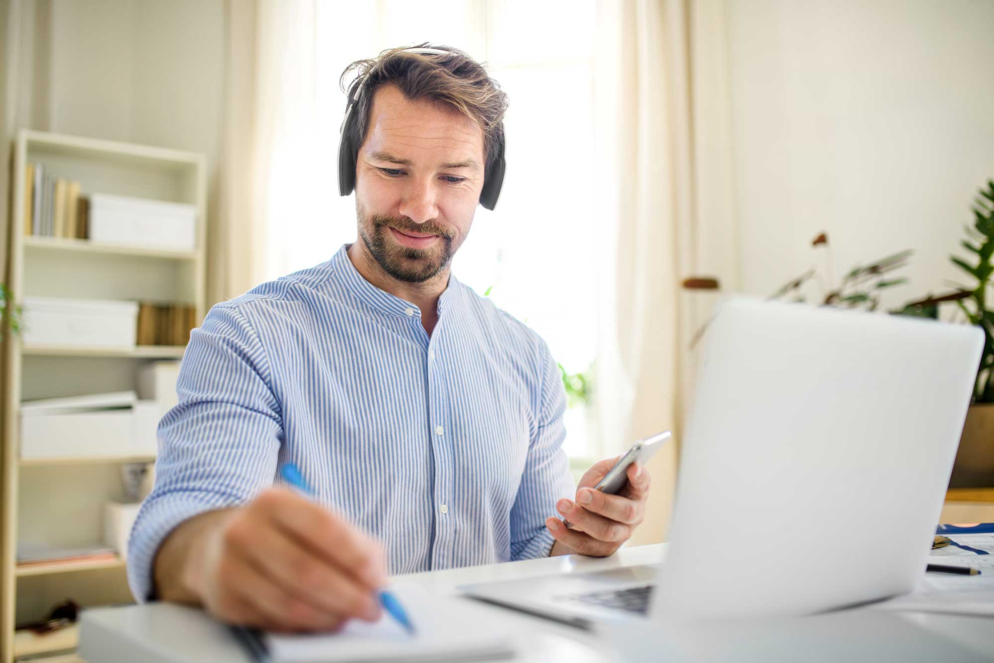 mature-businessman-with-headphones-and-laptop-indo-2022-02-02-03-59-12-utc.jpg